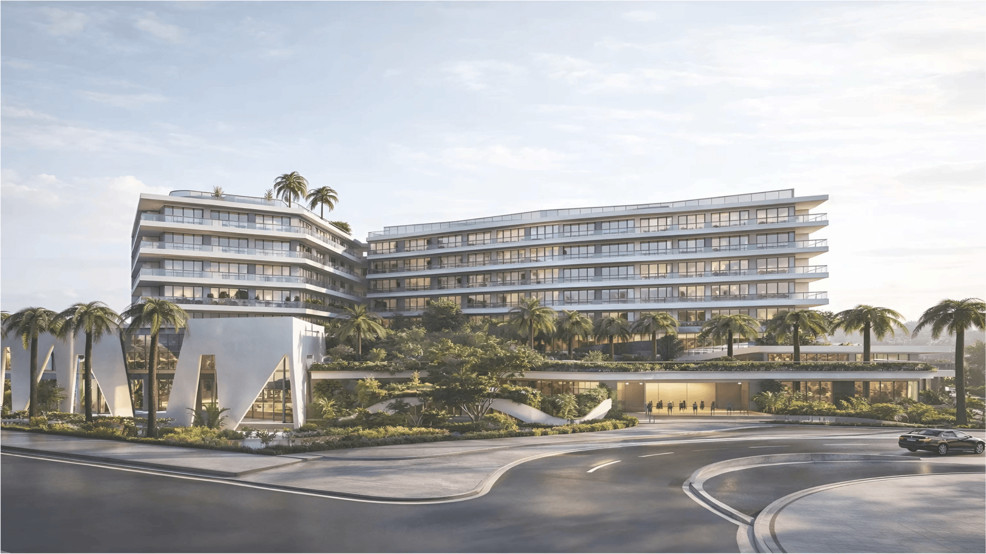 Exterior view of L’Aquila Residences condominium building in Aruba with landscaped surroundings