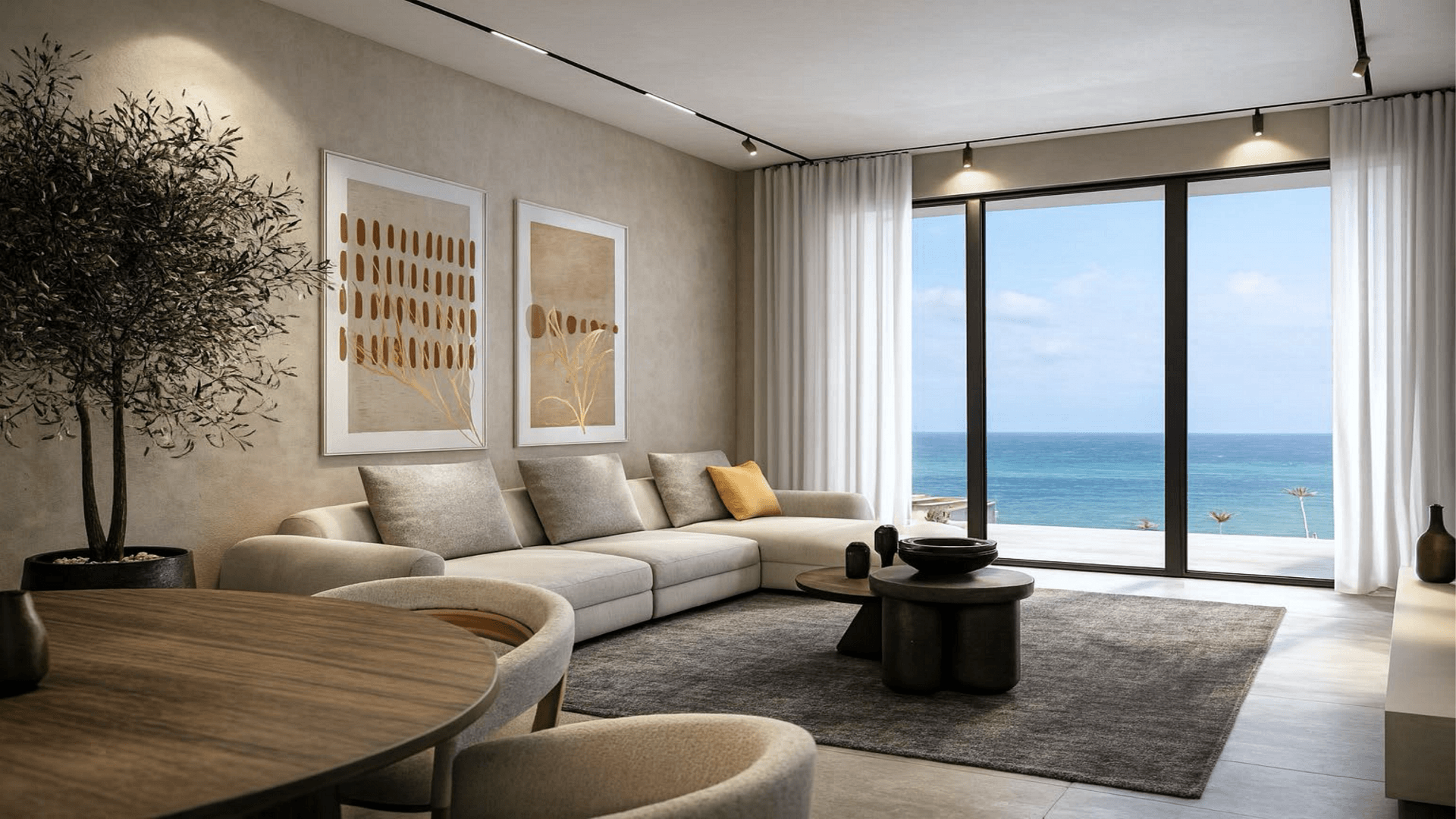 Living room with seating and ocean view windows in LAquila Residences Unit 103 type B condo in Aruba