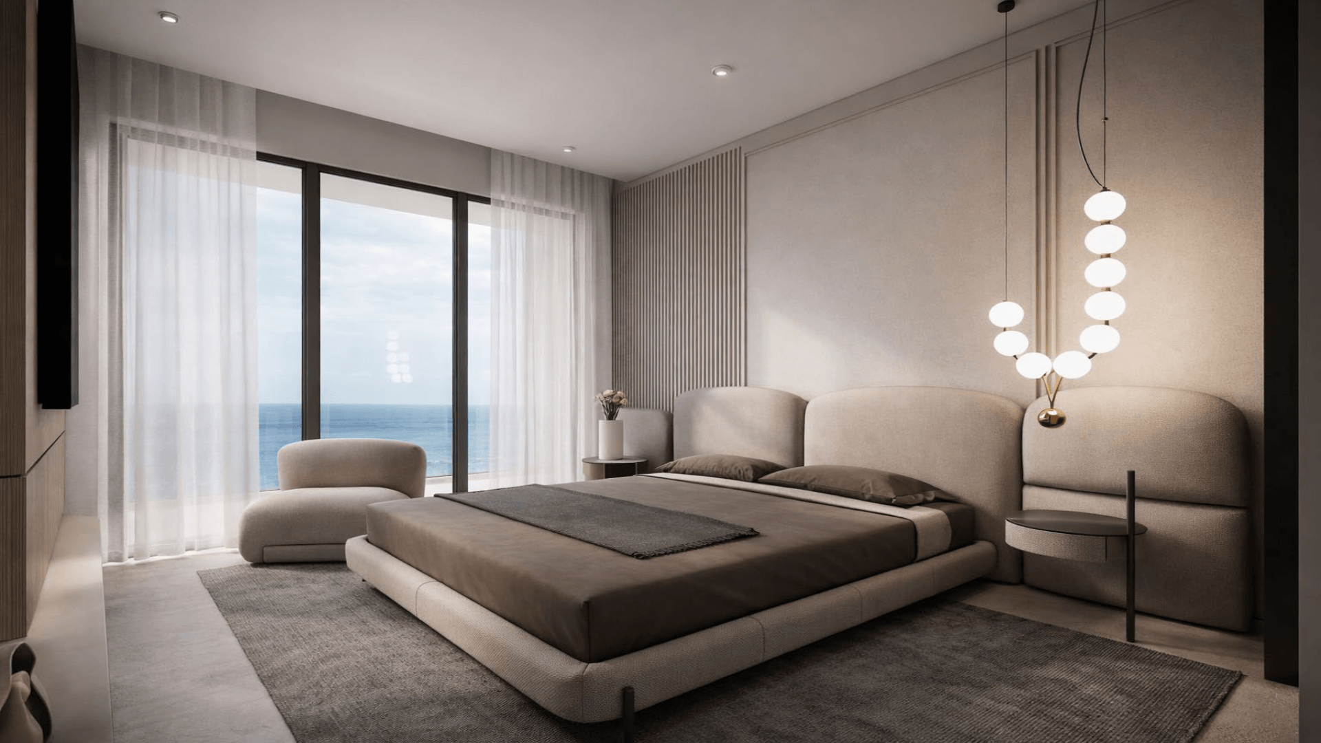 Bedroom interior in L’Aquila Residences Unit 201 type A featuring large windows and ocean view in Aruba