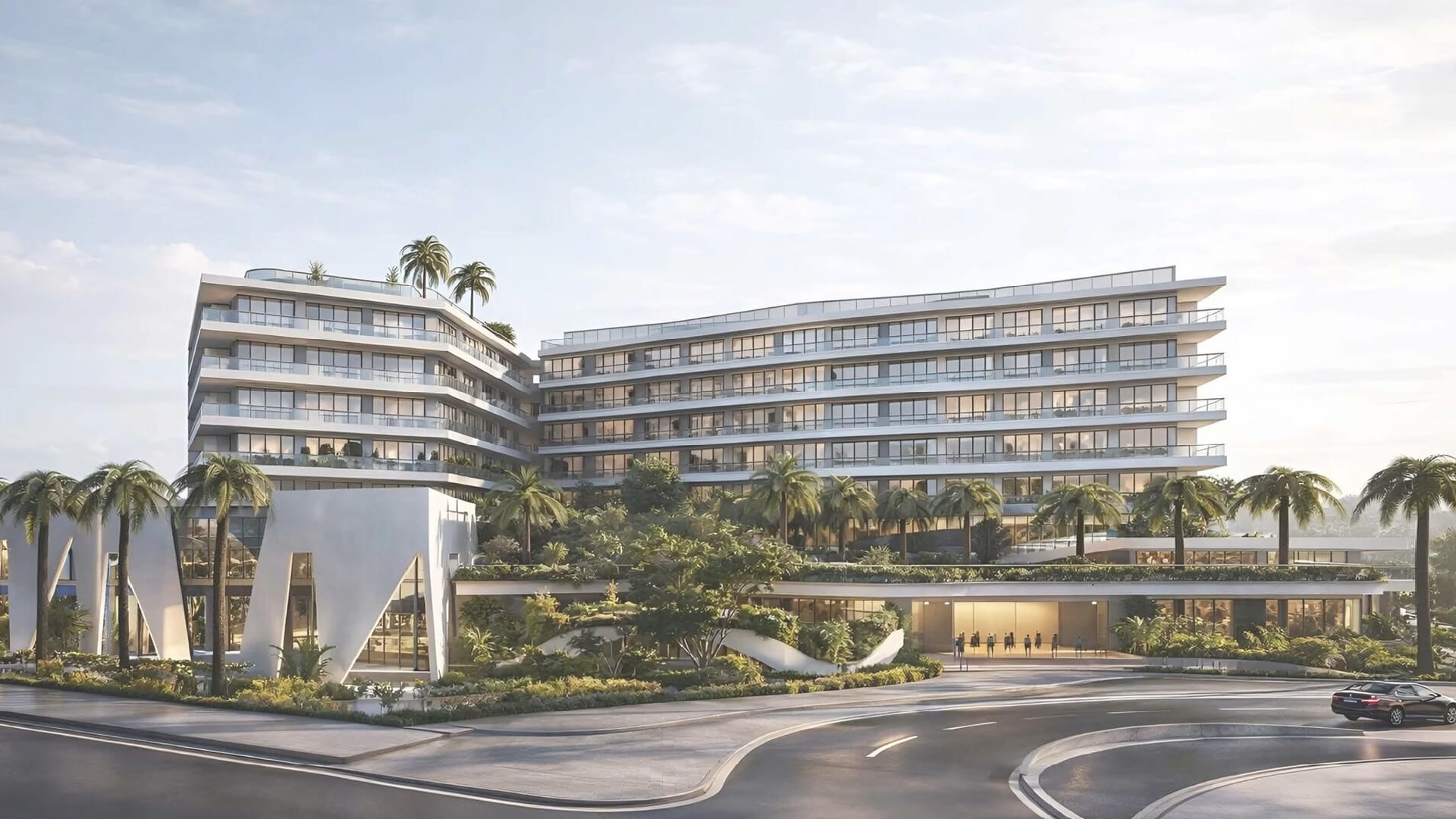 Exterior view of L’Aquila Residences building near Eagle Beach Aruba showcasing modern architecture and landscaped entrance