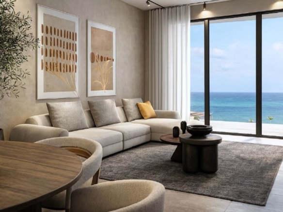 Living room with seating area and ocean view through large windows in L’Aquila Residences Unit 604 Type B Aruba