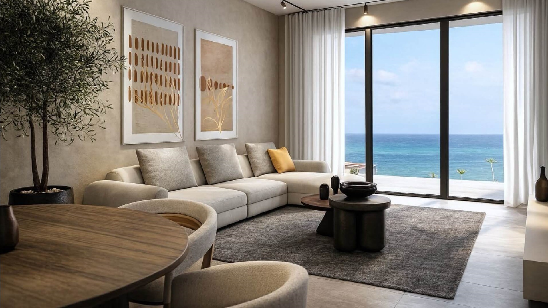 Living room with seating area and ocean view through large windows in L’Aquila Residences Unit 604 Type B Aruba