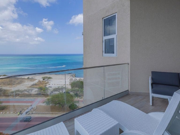 Balcony of Penthouse PHA at The Reef Residences with corner seating and ocean view in Eagle Beach Aruba