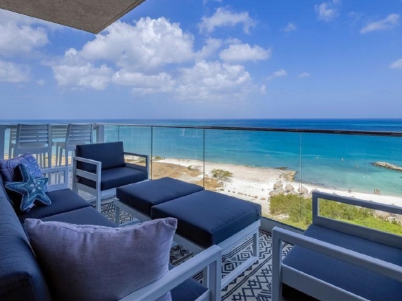 Balcony lounge of Penthouse PHA at The Reef Residences with oceanfront view in Eagle Beach Aruba