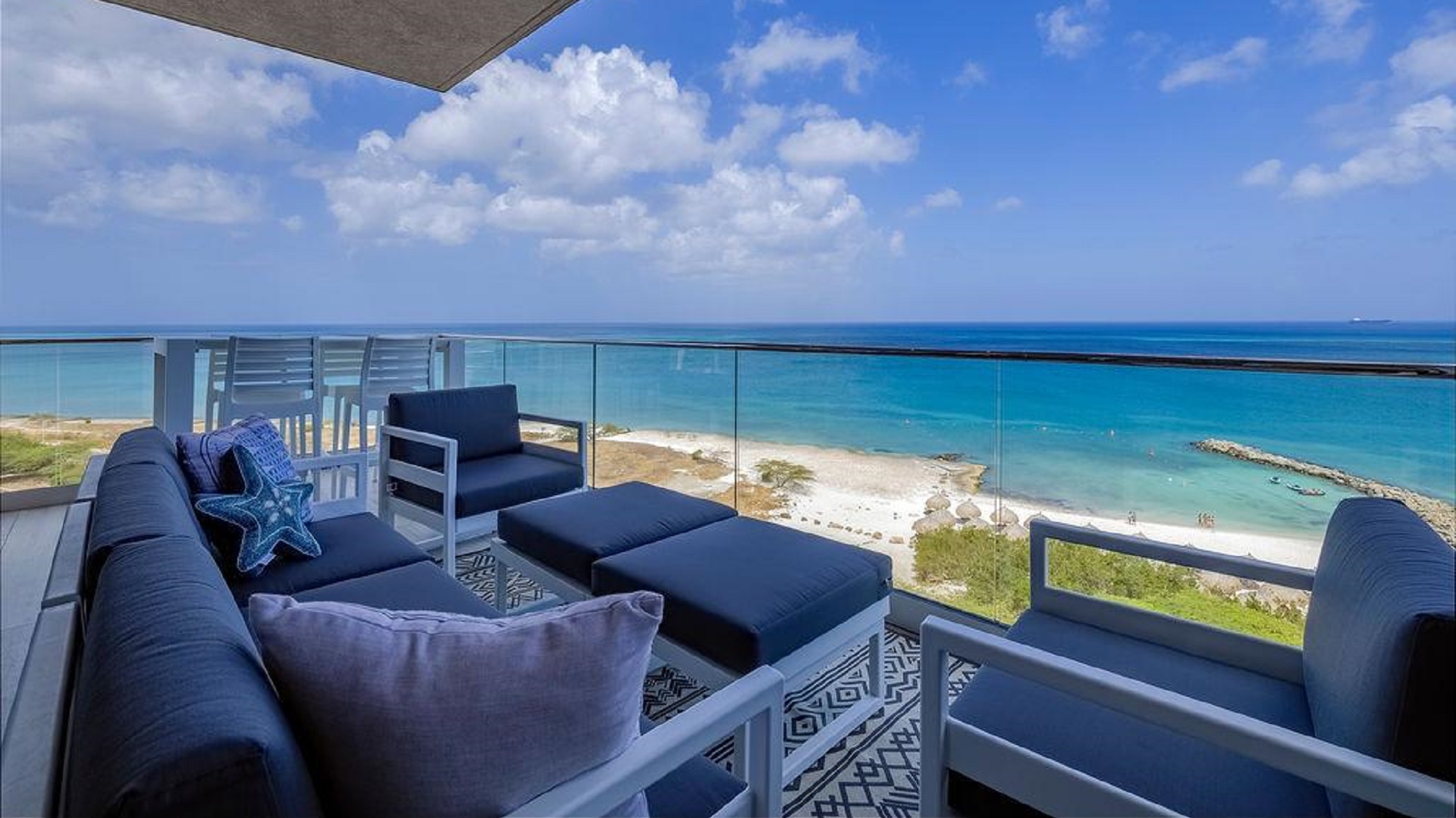 Balcony lounge of Penthouse PHA at The Reef Residences with oceanfront view in Eagle Beach Aruba