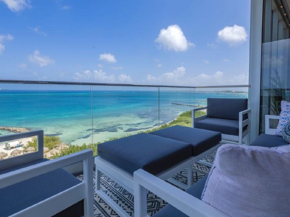 Balcony seating area of Penthouse PHA at The Reef Residences with side ocean view in Eagle Beach Aruba