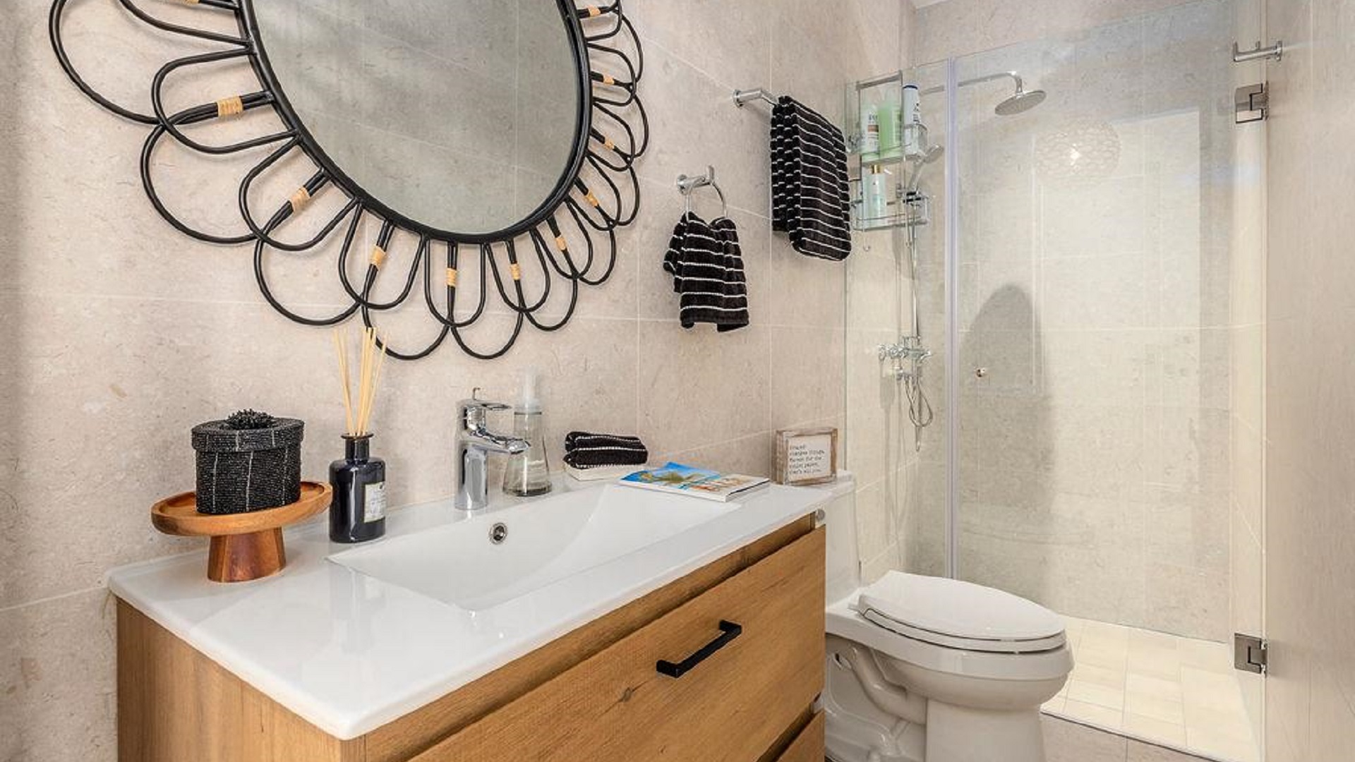 Bathroom in Penthouse PHA at The Reef Residences with decorative mirror and glass shower in Eagle Beach Aruba