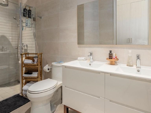 Bathroom in Penthouse PHA at The Reef Residences with double sink vanity and shower in Eagle Beach Aruba