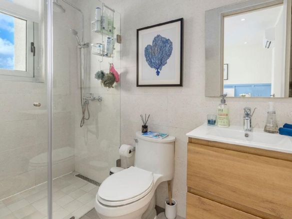 Bathroom in Penthouse PHA at The Reef Residences with single vanity and wood finish in Eagle Beach Aruba