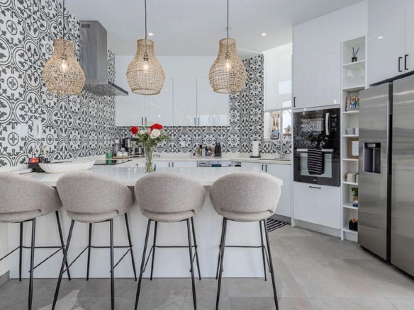 Kitchen island with seating in Reef Residences PHA penthouse featuring modern design in Eagle Beach Aruba