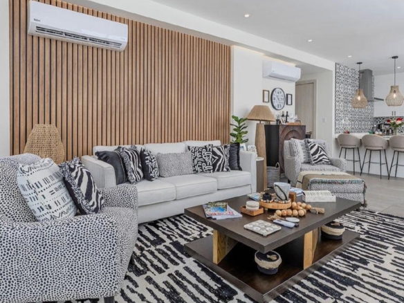 Open concept living room and kitchen in Reef Residences PHA penthouse with modern finishes in Eagle Beach Aruba