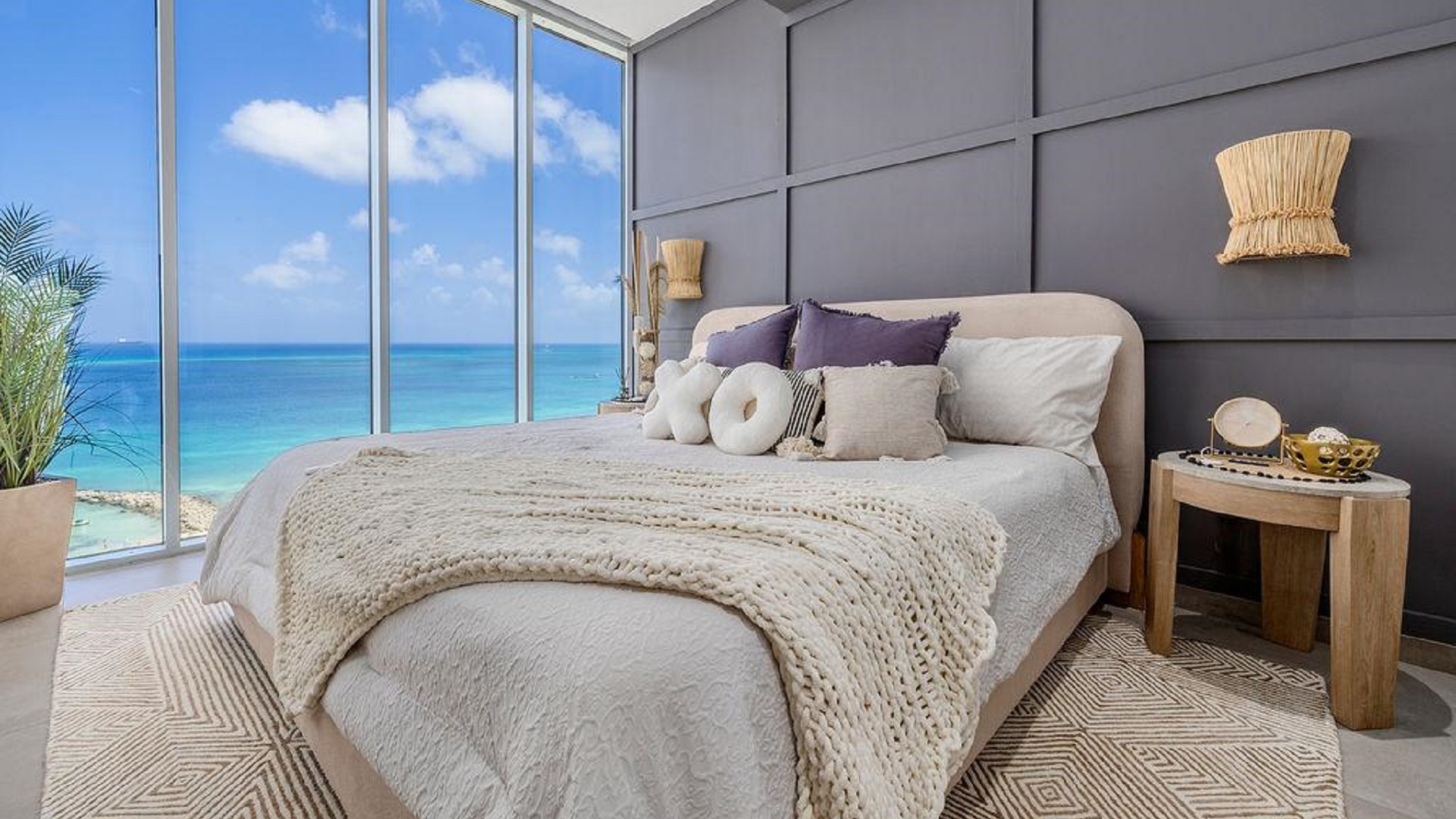 Master bedroom in Reef Residences PHA penthouse with ocean view windows in Eagle Beach Aruba