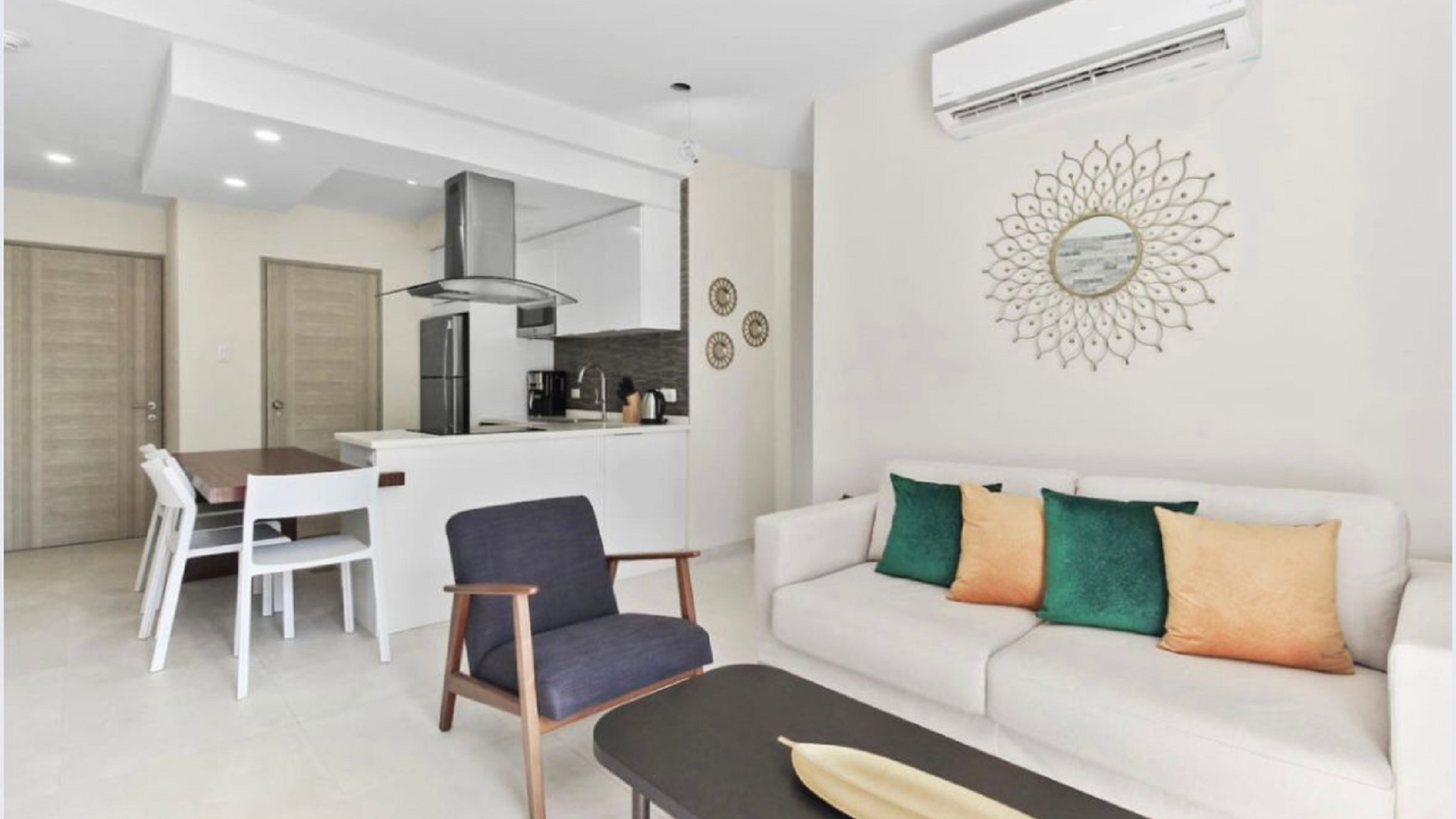 Open-concept living room and kitchen at the 2-Bedroom Oasis at Aracari in Aruba with sofa seating, dining table, and modern kitchen