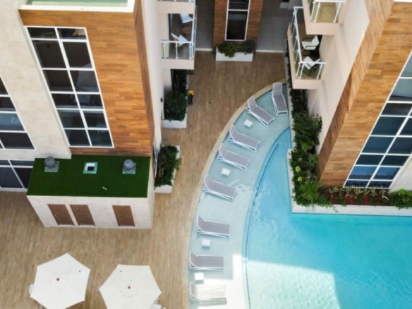 Aerial view of the pool courtyard at the 2-Bedroom Oasis at Aracari in Aruba featuring lounge chairs