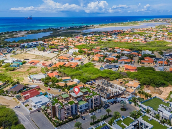 Aerial neighborhood and coastline view near Aracari Phase II condominium property in Aruba
