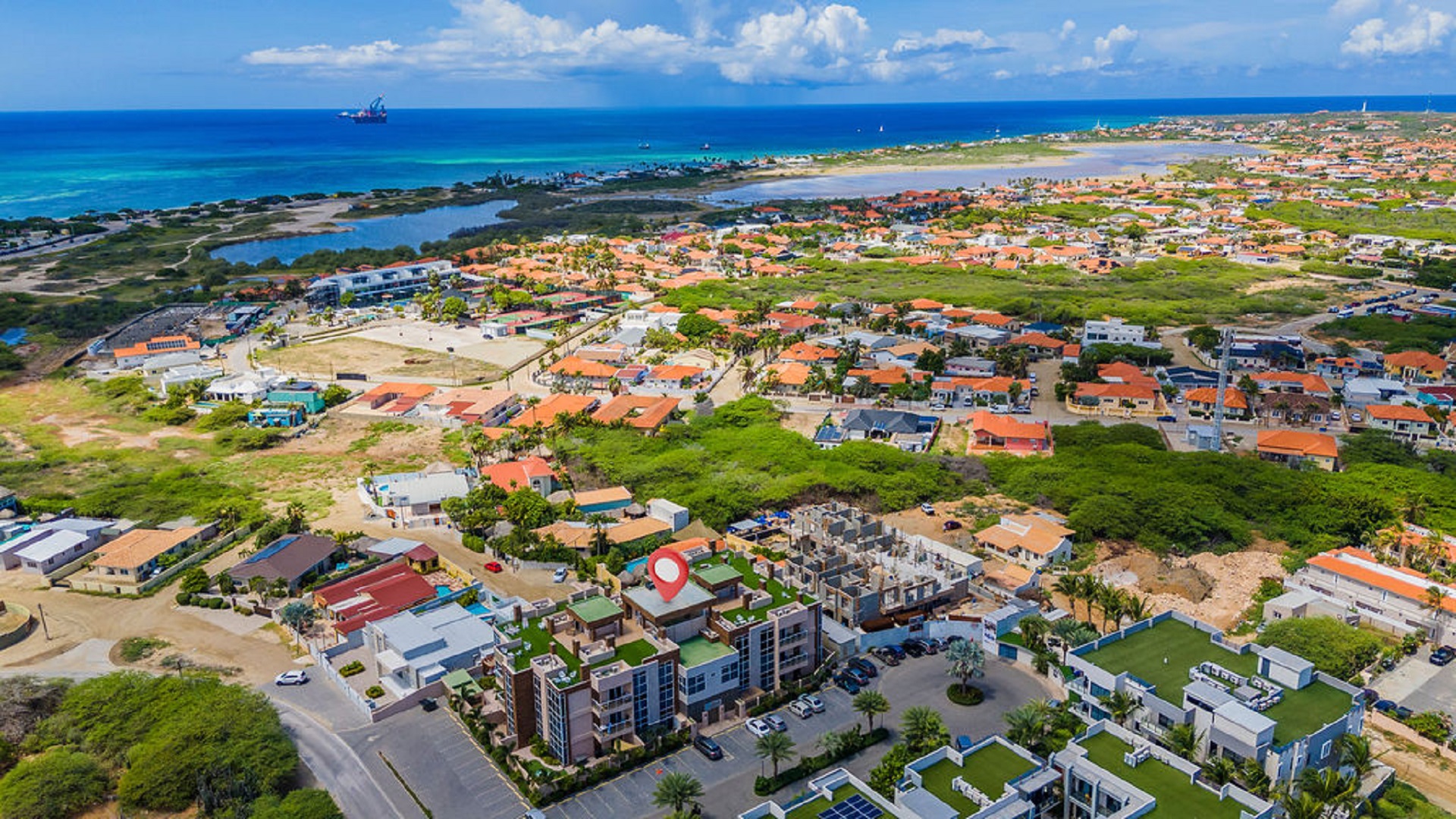 Aerial neighborhood and coastline view near Aracari Phase II condominium property in Aruba