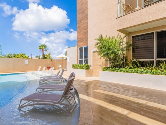Resort-style pool lounge area at Aracari Phase II condominium property in Aruba