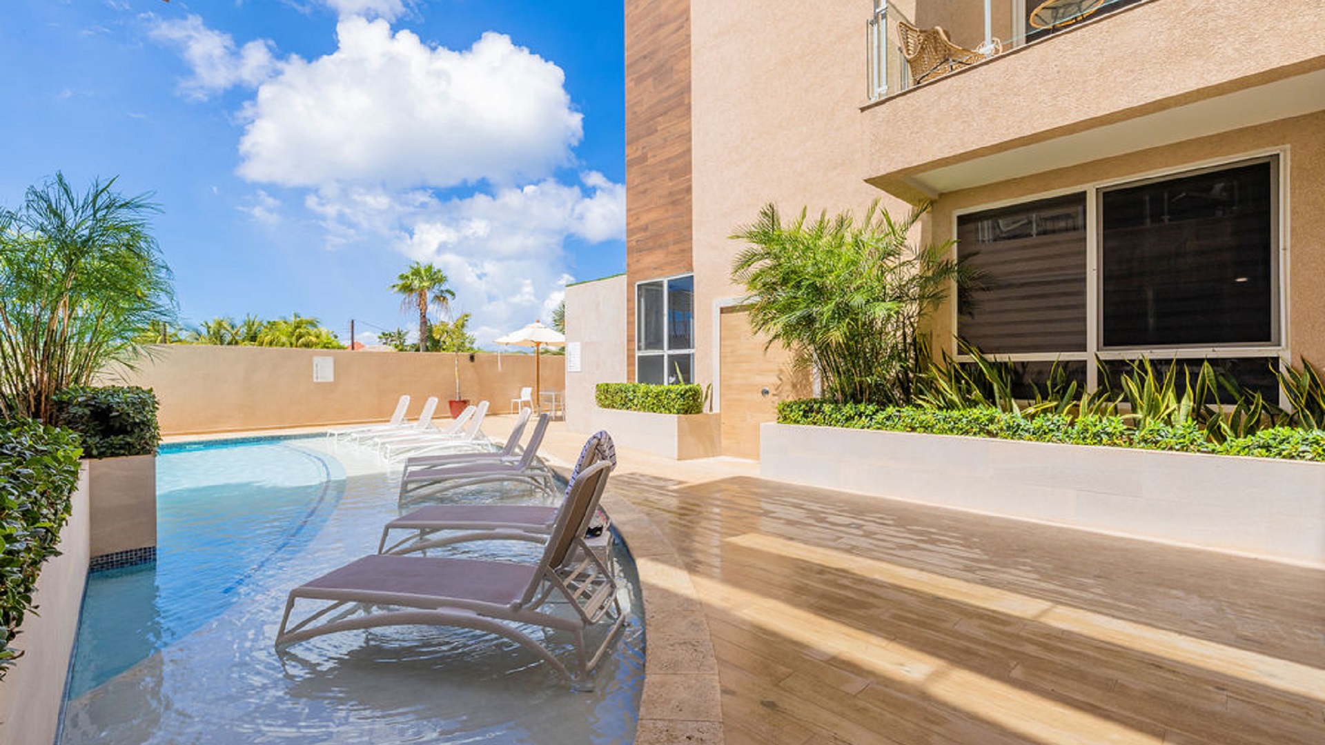 Resort-style pool lounge area at Aracari Phase II condominium property in Aruba
