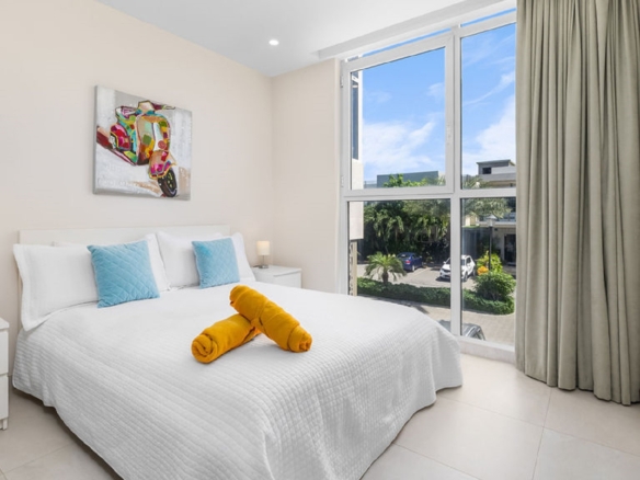 Bedroom with large windows and outdoor view at Aracari Phase II Unit 13 in Aruba