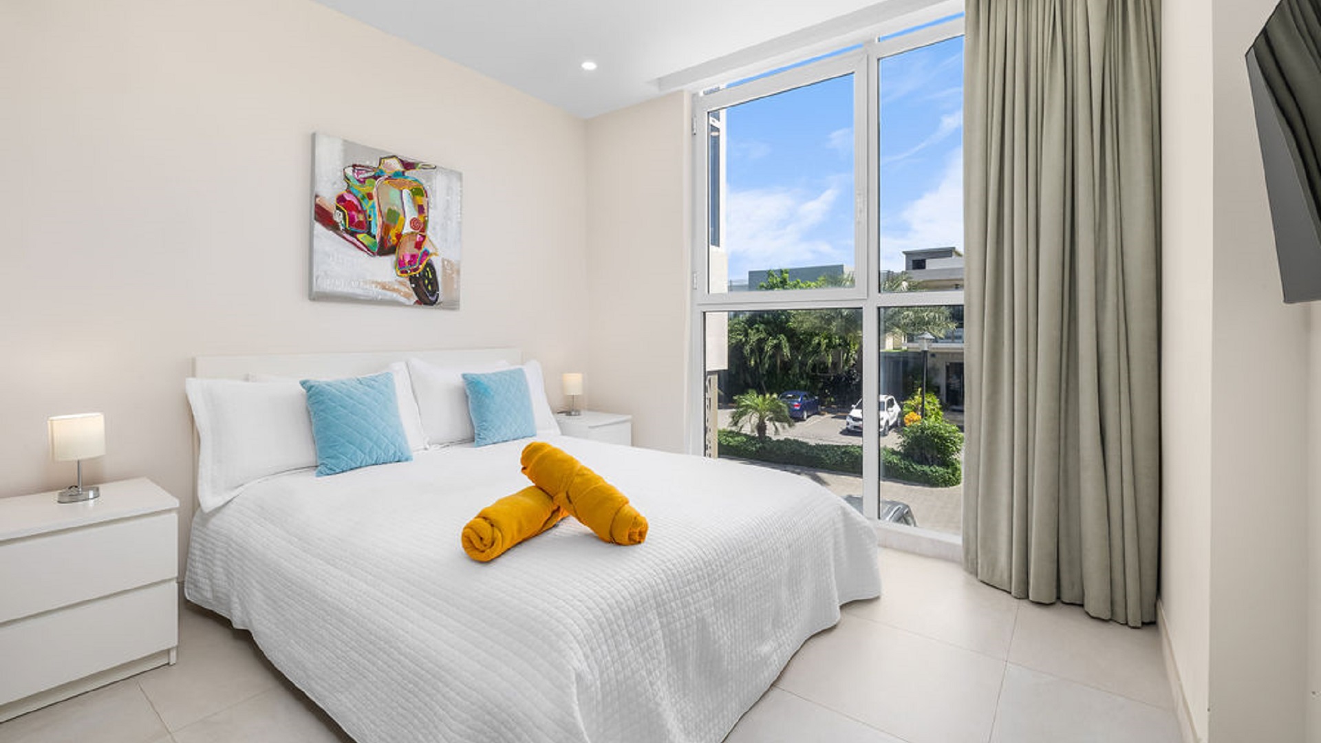 Bedroom with large windows and outdoor view at Aracari Phase II Unit 13 in Aruba