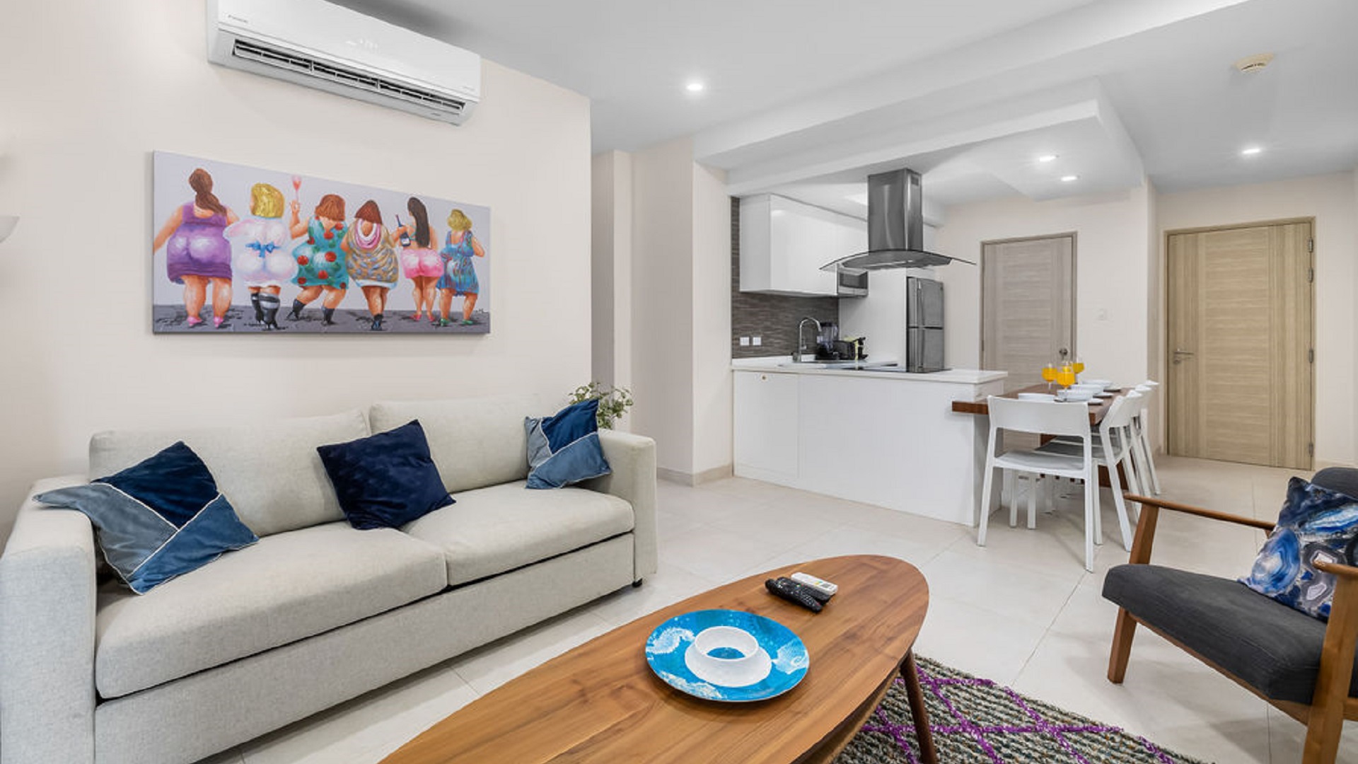 Living room and kitchen area inside Aracari Phase II Unit 13 condo in Aruba with modern furnishings and open layout