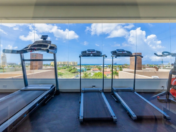 Fitness room with treadmills and ocean views at Aracari Phase II in Aruba