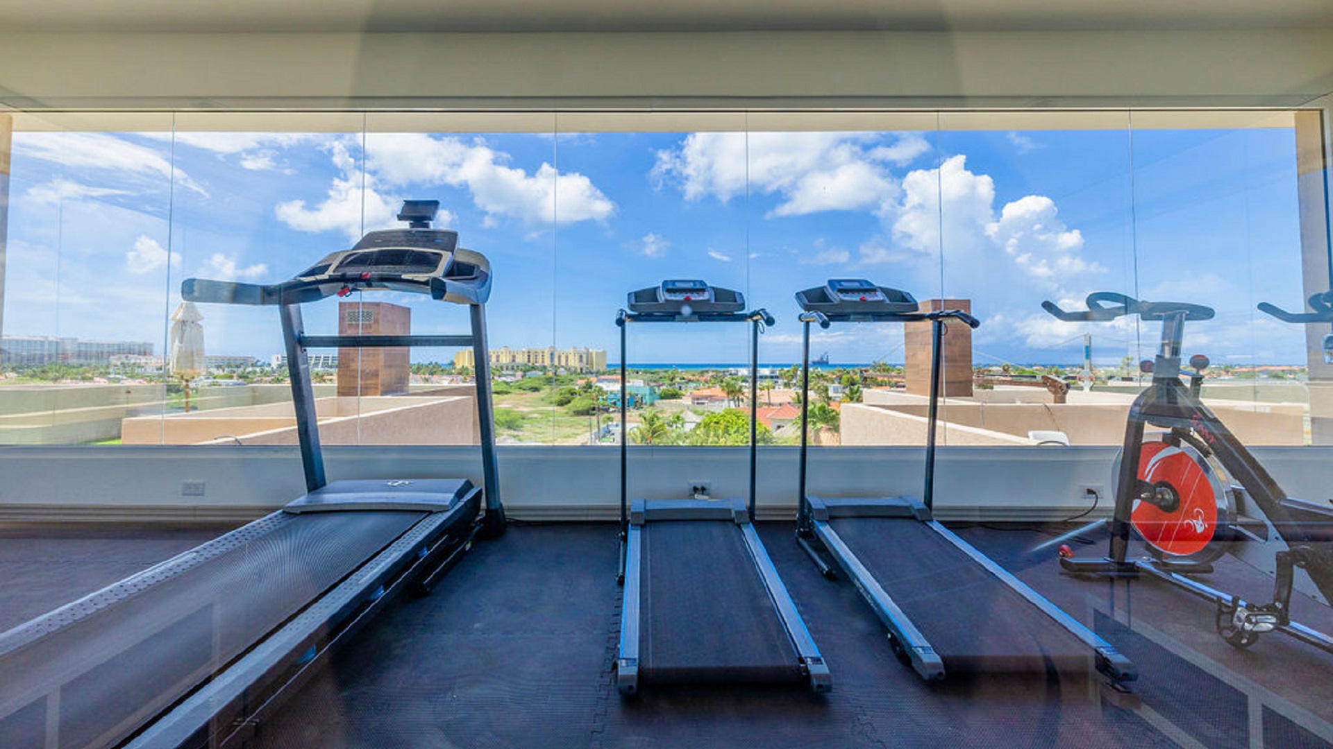 Fitness room with treadmills and ocean views at Aracari Phase II in Aruba