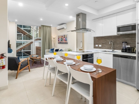 Kitchen and dining area inside Aracari Phase II Unit 13 condo in Aruba with modern appliances and dining table