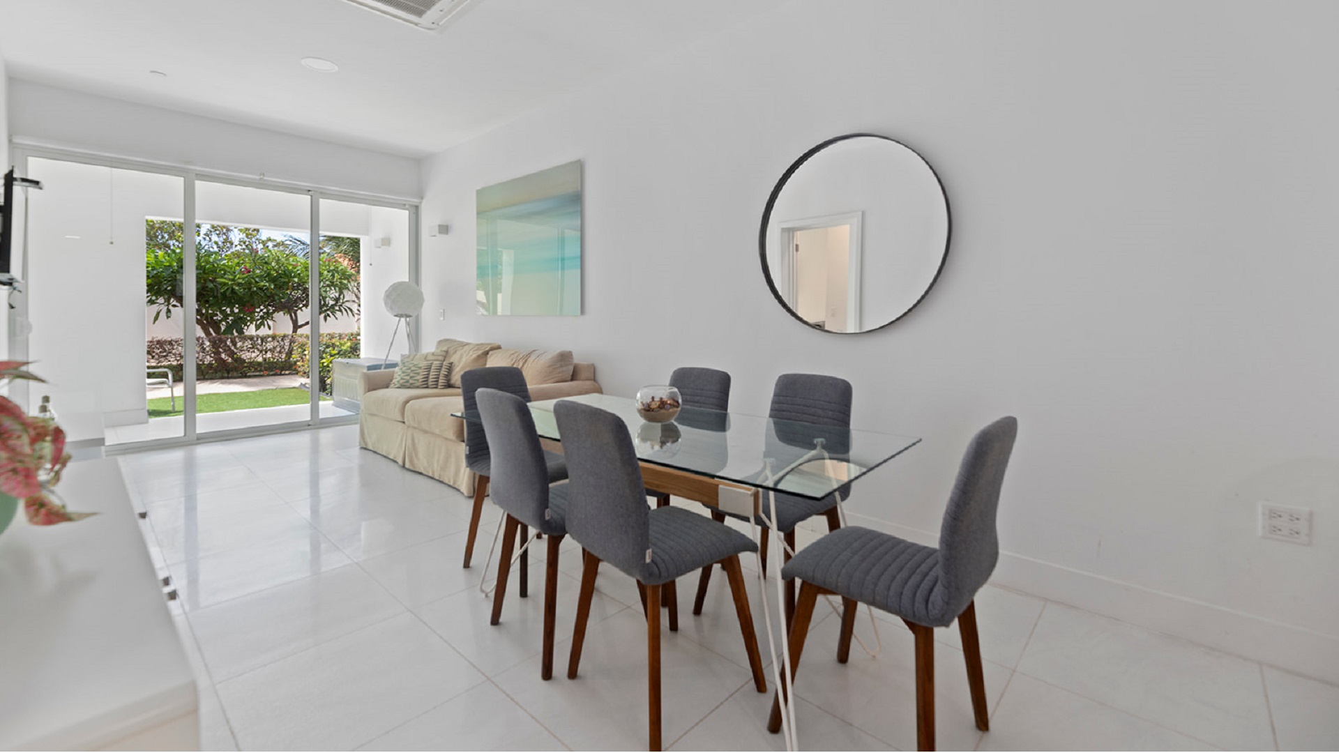 Dining and living area with patio access in Aruba’s Life Garden 2 bedroom condo