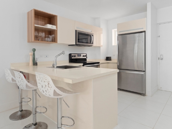 Modern kitchen with breakfast bar inside Aruba’s Life Garden 2 bedroom condo in Aruba