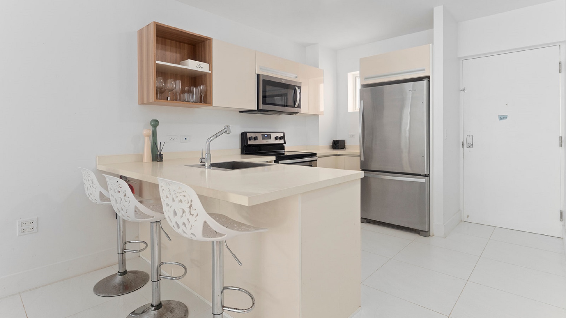 Modern kitchen with breakfast bar inside Aruba’s Life Garden 2 bedroom condo in Aruba