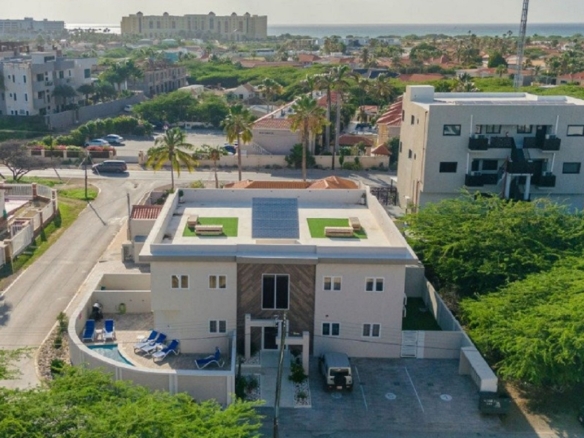 Aerial view of the Summerside 2-bedroom condo property in Rooi Santo, Aruba showing the building, pool area, and nearby coastline.