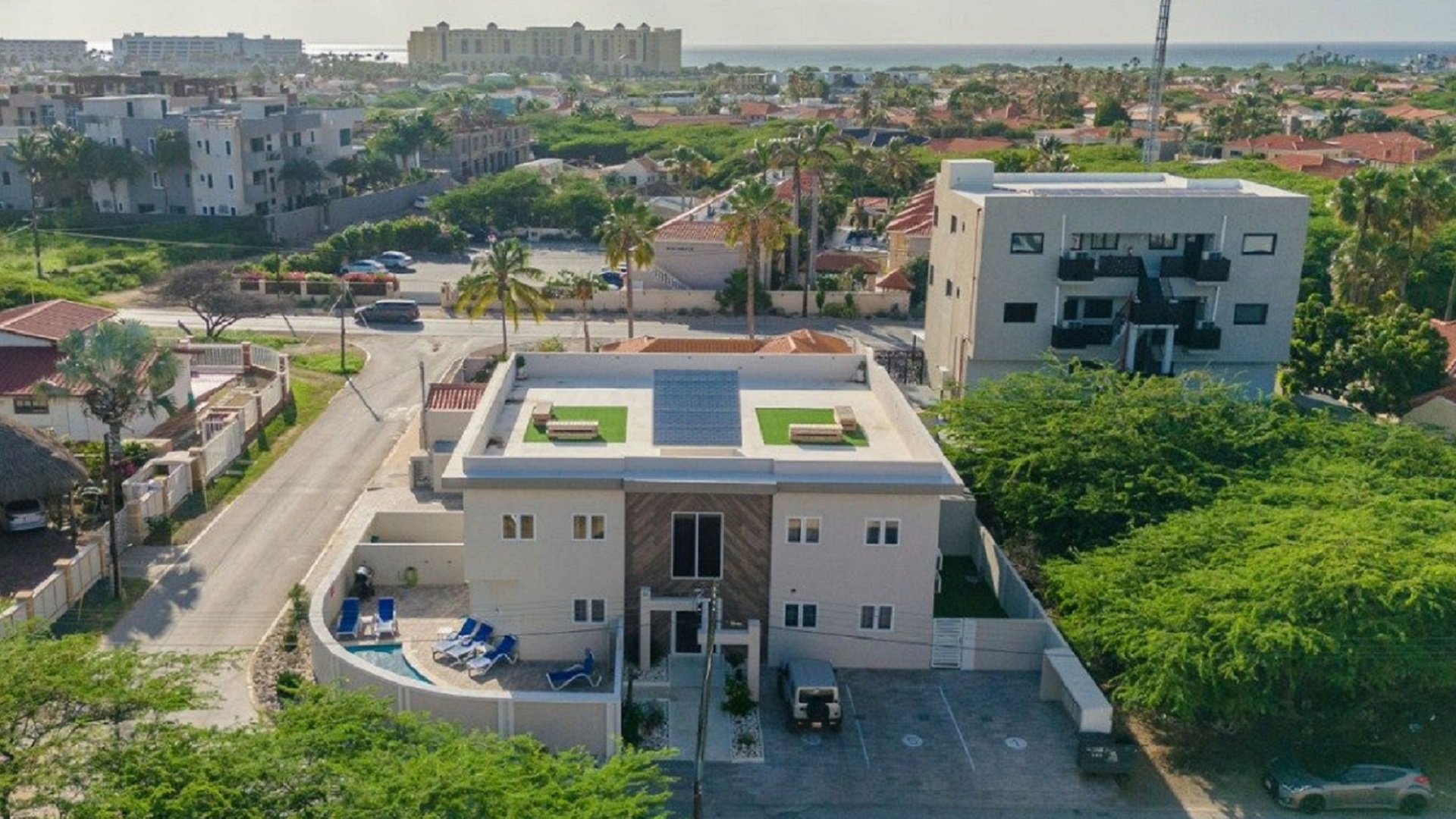Aerial view of the Summerside 2-bedroom condo property in Rooi Santo, Aruba showing the building, pool area, and nearby coastline.