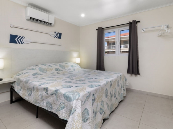 Bedroom interior at the Summerside 2-bedroom condo in Rooi Santo, Aruba with air conditioning and natural light.