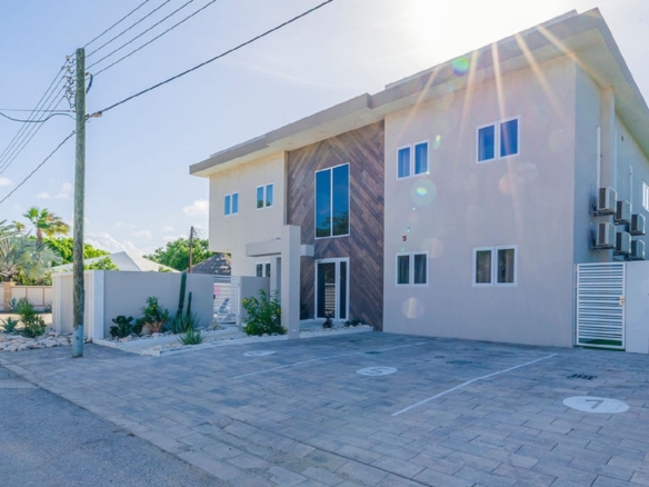 Front exterior view of the Summerside 2-bedroom condo in Rooi Santo, Aruba with modern design and private parking area.
