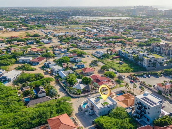Wide aerial view of the Rooi Santo neighborhood in Aruba featuring the Summerside condo location and nearby residential area.