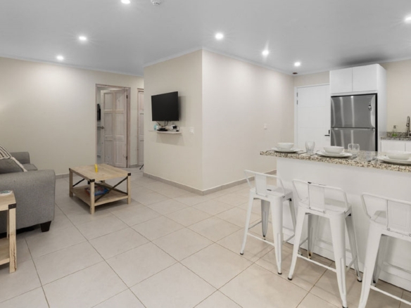 Open-concept living room and kitchen inside the Summerside 2-bedroom condo in Rooi Santo, Aruba.