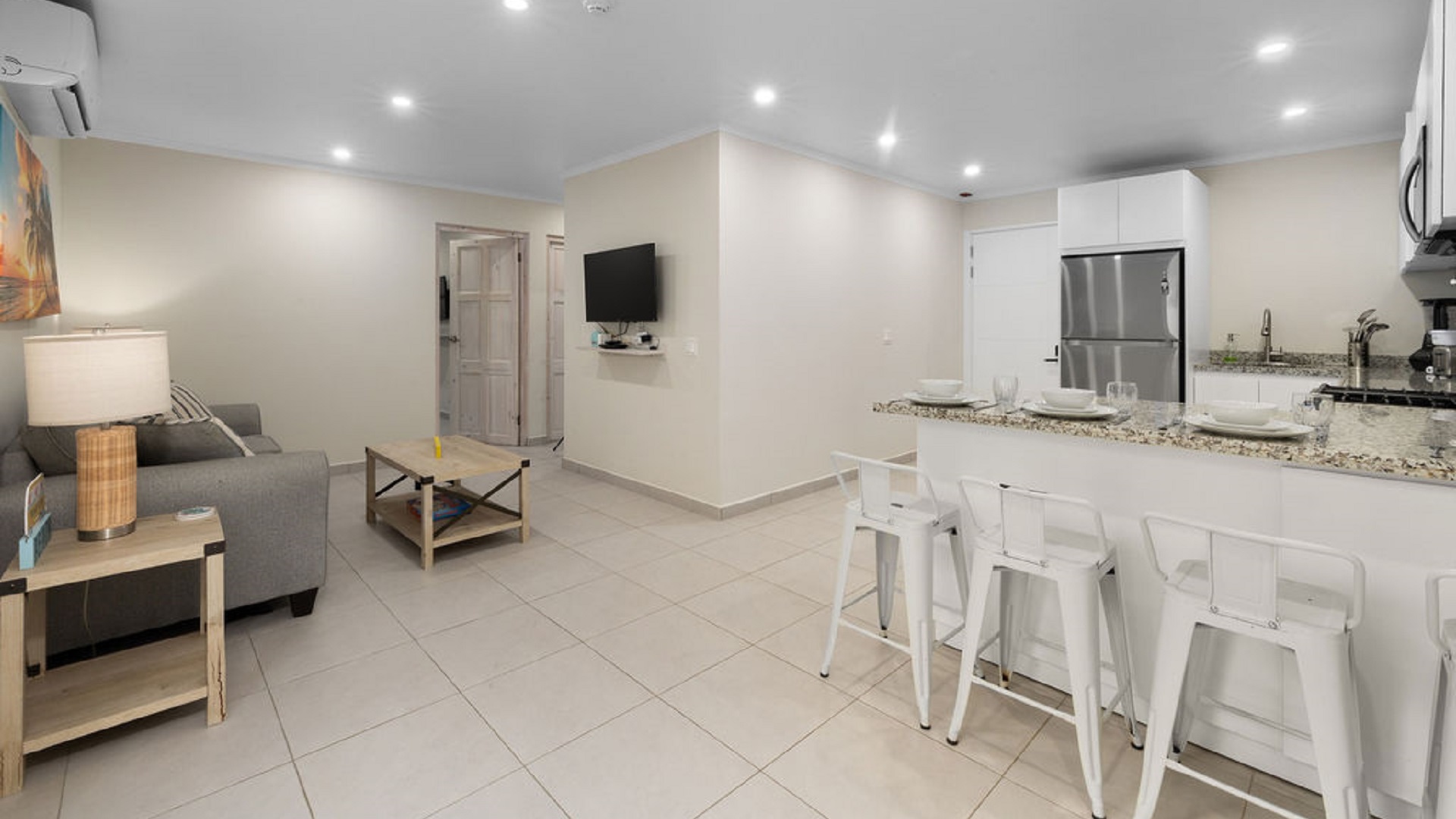 Open-concept living room and kitchen inside the Summerside 2-bedroom condo in Rooi Santo, Aruba.