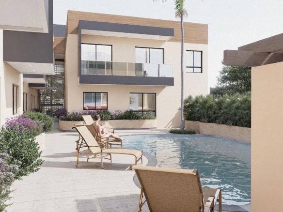 Community pool view at Summerside III townhouse featuring lounge chairs and outdoor bar area