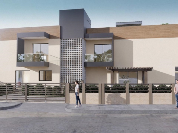 Corner exterior view of Summerside III townhouse showcasing balconies, fencing, and landscaping