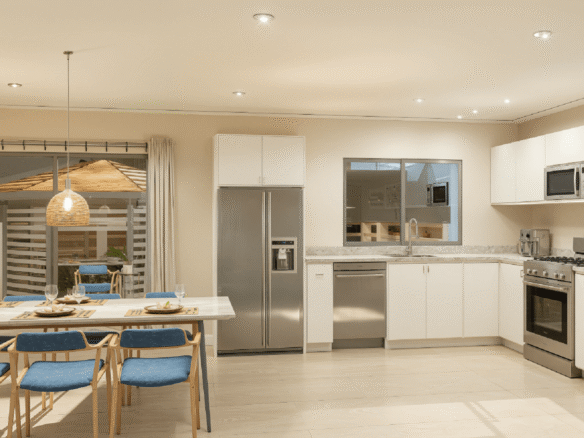 Modern kitchen and dining area inside Summerside III townhouse with stainless steel appliances and white cabinets