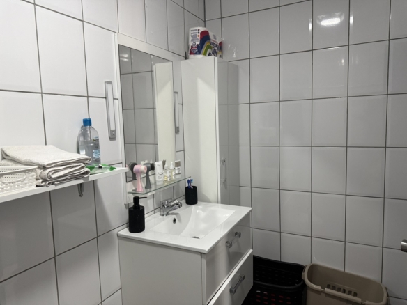 Bathroom vanity and storage cabinet inside the Alto Vista 26 W apartment in Aruba.