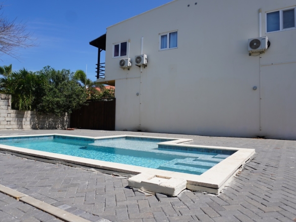 Gazebo seating area overlooking the shared swimming pool at Alto Vista 26 W in Aruba.