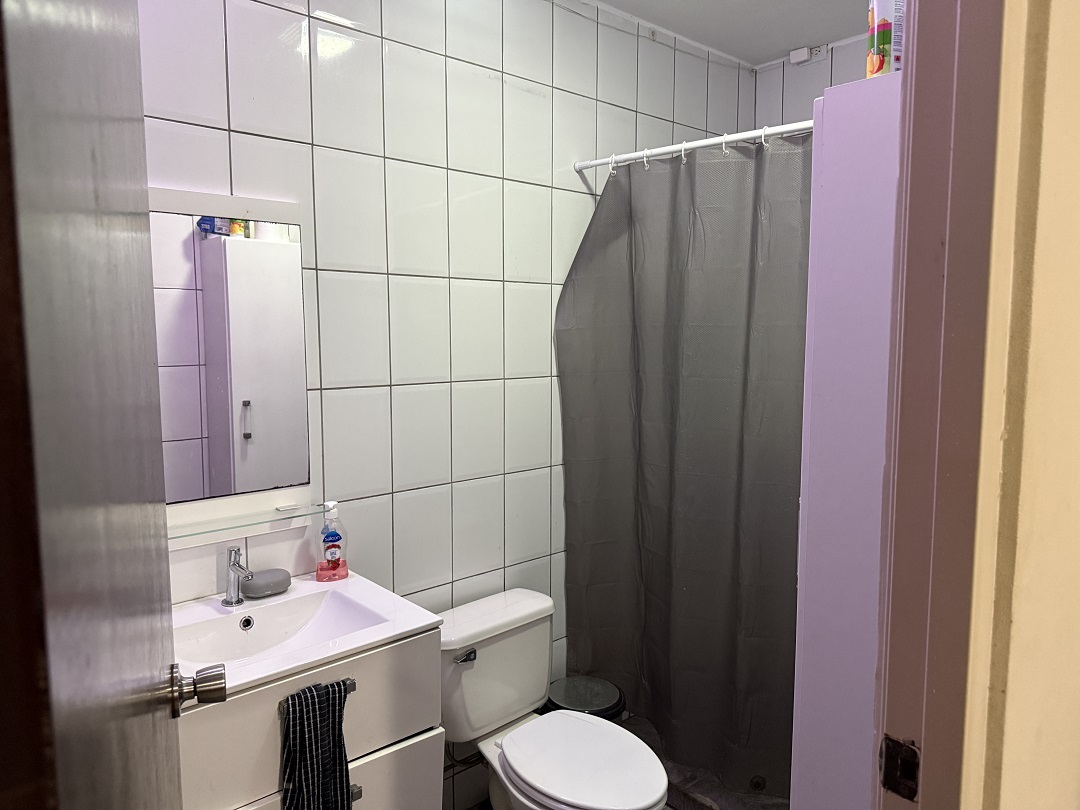 Bathroom featuring a shower, vanity, and toilet in the Alto Vista apartment.