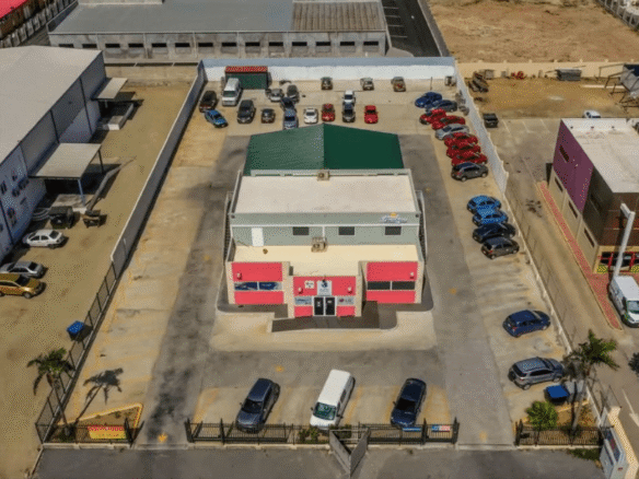 Aerial view of the Commercial Office Space for Rent at Schotlandstraat 77-A Aruba showing the building exterior and surrounding parking spaces.