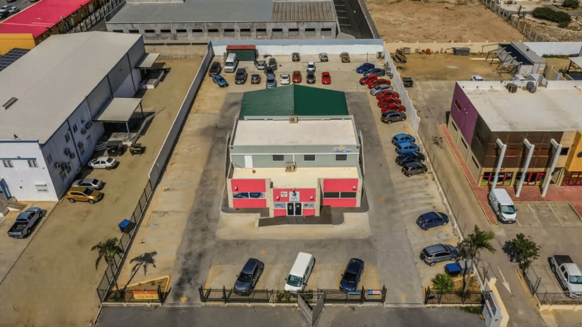 commercial-office-space-schotlandstraat-77-a-building-exterior-aerial-aruba-for-rent Aerial view of the Commercial Office Space for Rent at Schotlandstraat 77-A Aruba showing the building exterior and surrounding parking spaces.