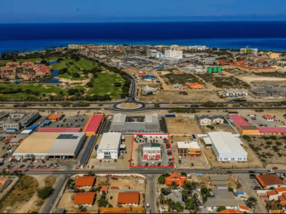 Wide aerial view of the Commercial Office Space for Rent at Schotlandstraat 77-A Aruba within the surrounding commercial district and nearby coastline.
