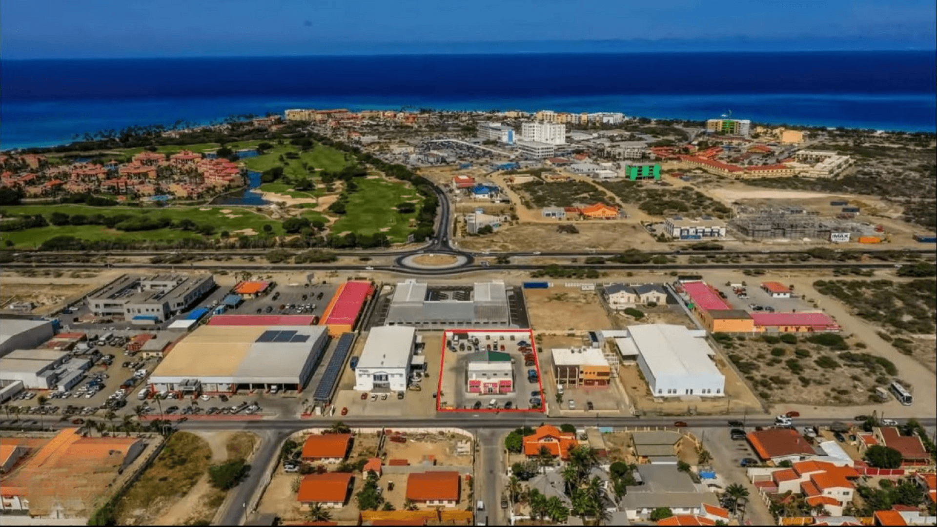 Wide aerial view of the Commercial Office Space for Rent at Schotlandstraat 77-A Aruba within the surrounding commercial district and nearby coastline.