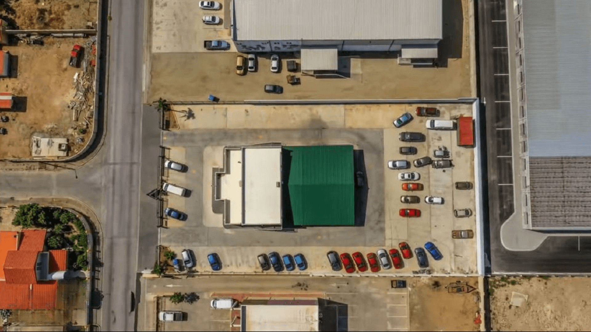 Aerial top-down view of the Commercial Office Space for Rent at Schotlandstraat 77-A Aruba showing the office building, paved parking areas, and surrounding commercial properties.