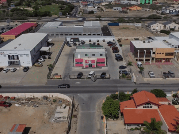 Centered aerial view of the Commercial Office Space for Rent at Schotlandstraat 77-A Aruba highlighting the building frontage and parking layout.